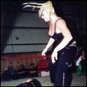 The bigger blonde wrestler knocks Lacey to the mat.