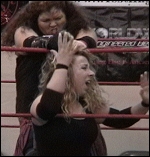 Alicia suffers as much as her partner in this match. Here, the rookie is screaming in agony as McLean yanks at her hair while working her in the ring ropes.