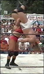 Victoria easily lifts and bodyslams Johnny Rayz to the mat.