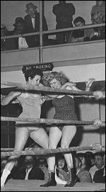 Fans were always amazed at Lola's mean streak. Here Ms. LaRay grinds a forearm across Vicky Lynn's throat while pounding away with a right fist to the body. Fans were always amazed at Lola's mean streak. Here Ms. LaRay grinds a forearm across Vicky Lynn's throat while pounding away with a right fist to the body.