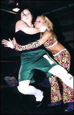 Mickie has the headlock in place as she prepares to take Daizee Haze down to the mat.