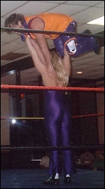 The Firebird shows off her impressive strength as she presses her male opponent high overhead.