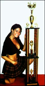 Traci proudly displays her WXW Women's Super 8 Tournament trophy.
