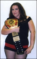 Kacee Carlisle poses with one of her several championship title belts.